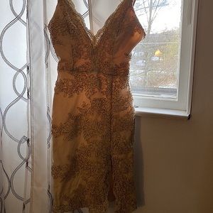 Worn once, adjustable straps, size small, short gold dress, slit in leg